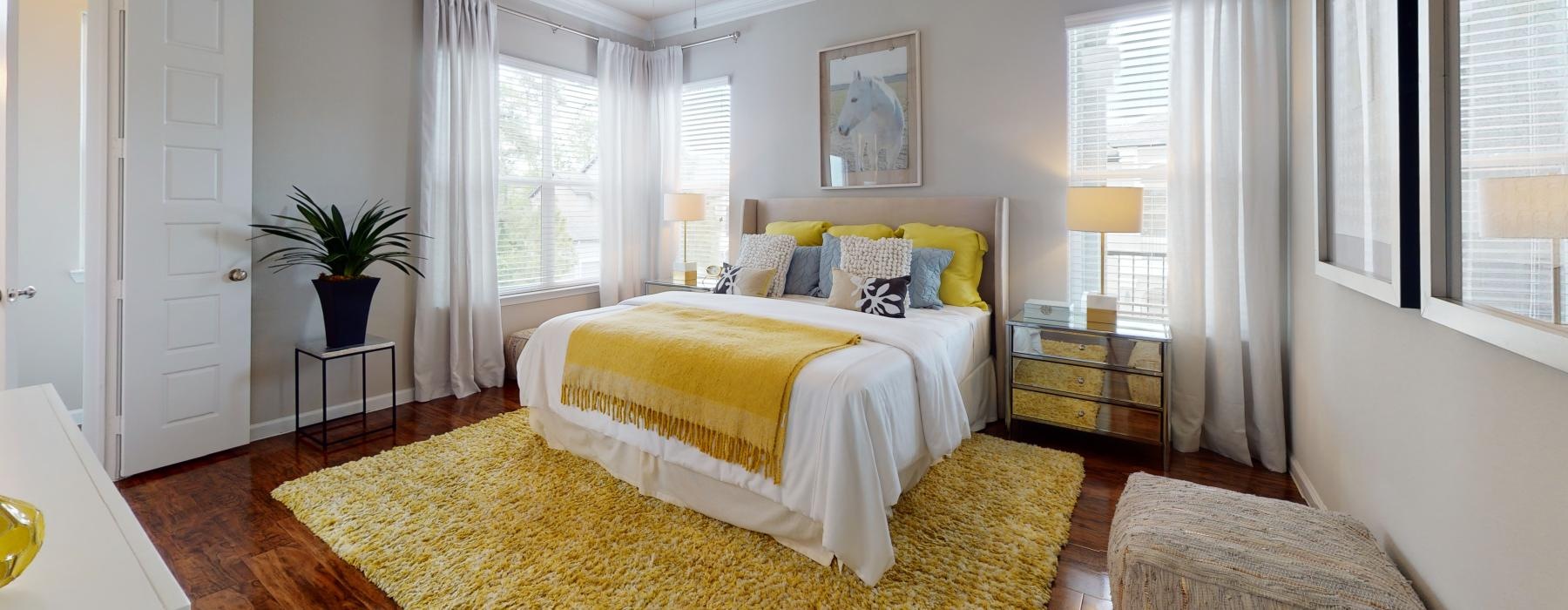 a bedroom with a bed and a fan