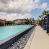 a large long pool with covered seating areas