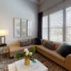 a couch a coffee table and windows