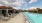 a pool with lounge chairs around it