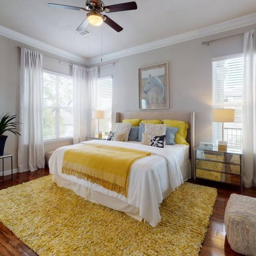 a bedroom with a bed and a fan