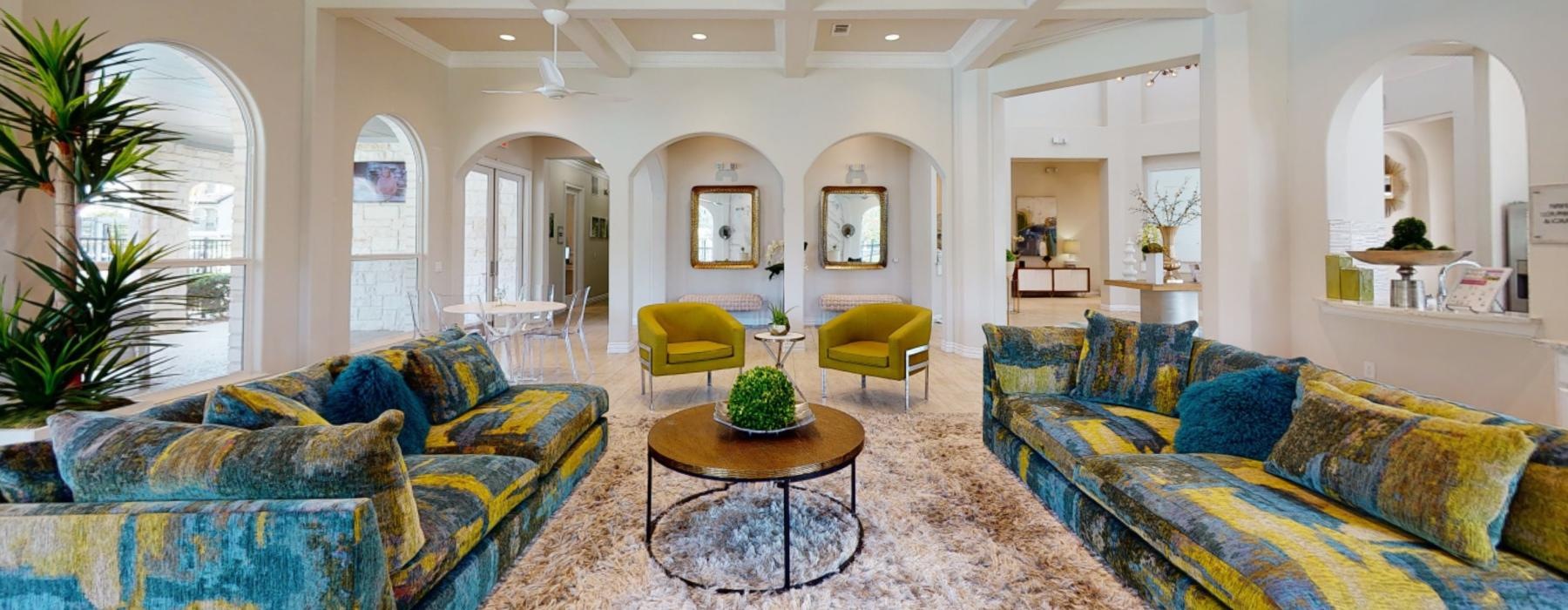 a large living room with a large chandelier and a large glass door
