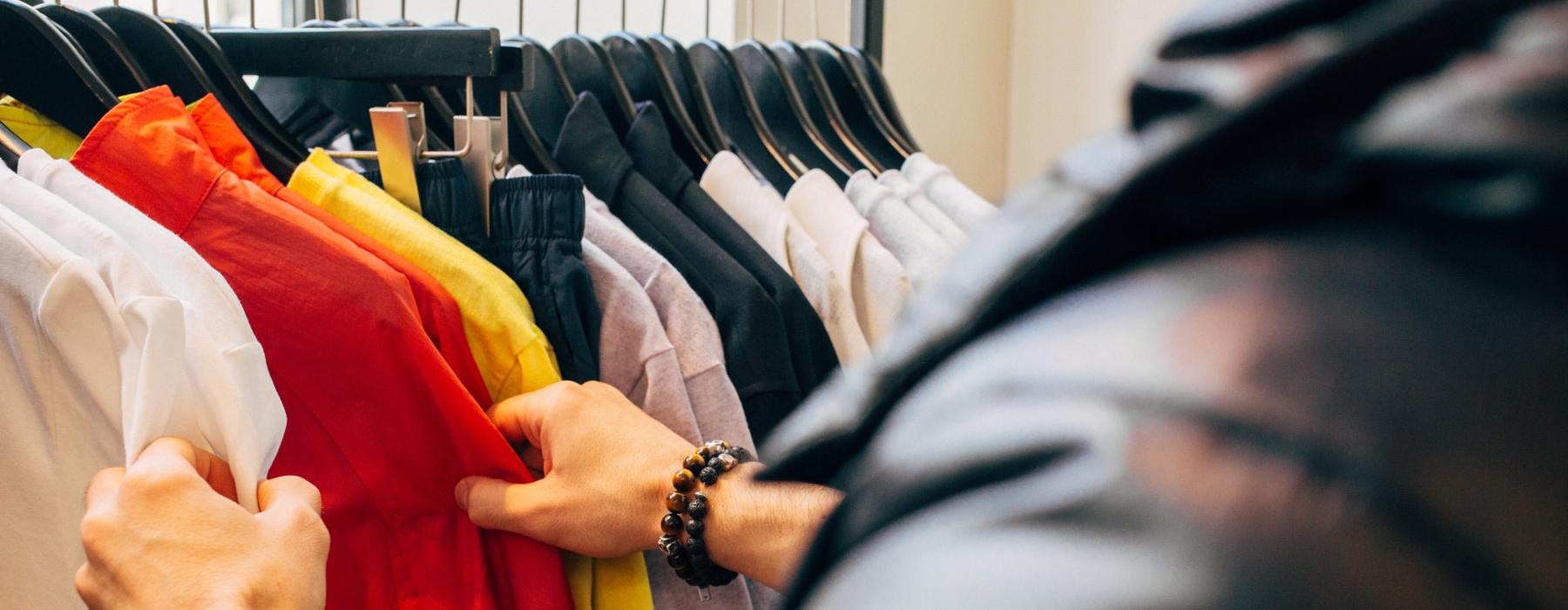 a man looking through clothes