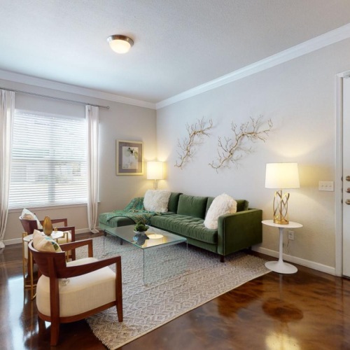 a living room with a green couch and a coffee table